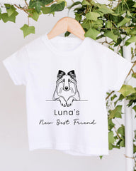 A white t-shirt with a black graphic design of a dog's face and the text "Luna's New Best Friend" printed on it.
