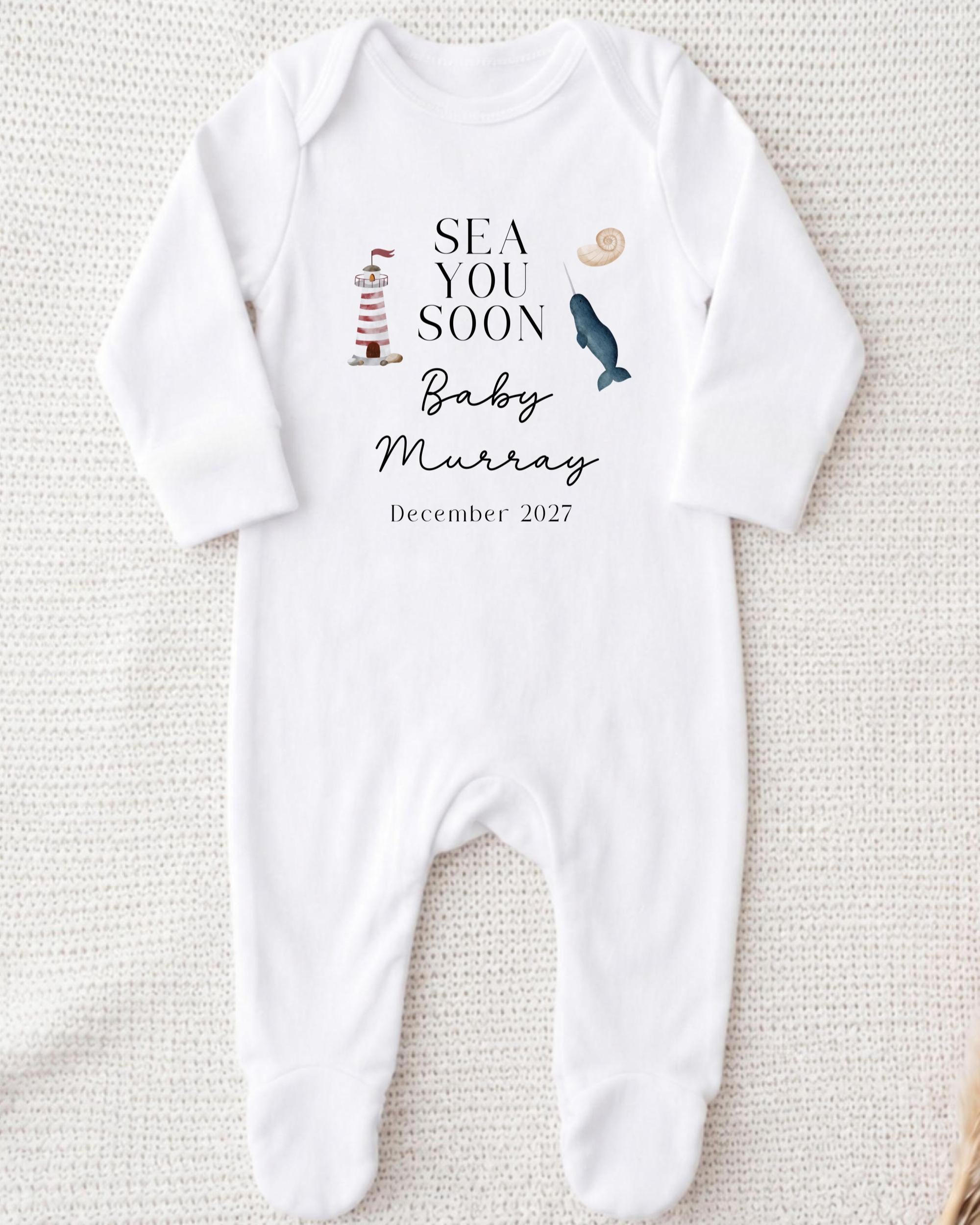 A white onesie with text and illustrations related to a baby announcement.