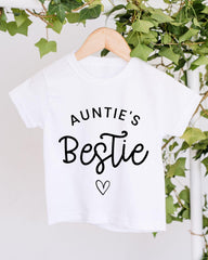 A white t-shirt with the text "Auntie's Bestie" printed on it, along with a heart symbol.