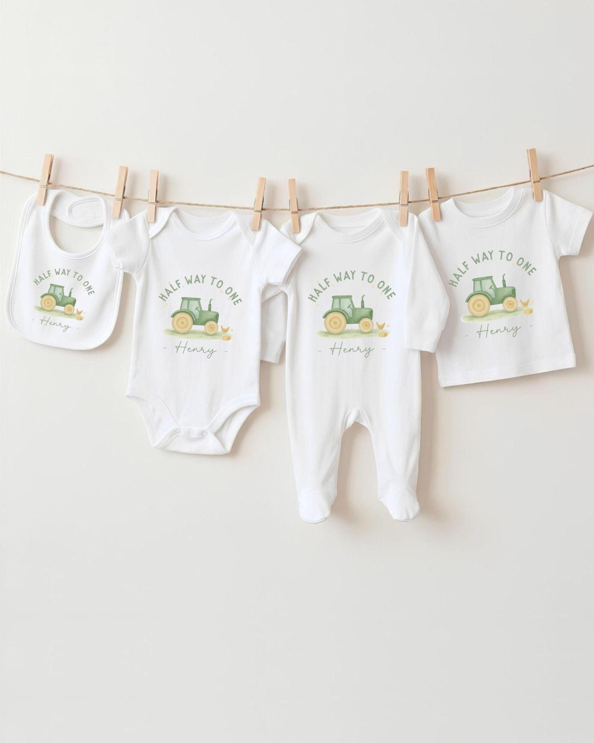 A collection of baby clothes, including onesies and bibs, hanging on a clothesline.