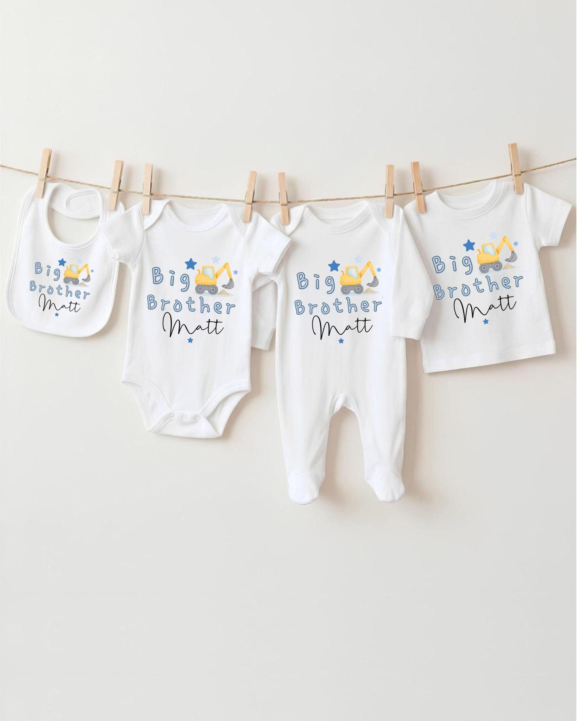 A row of four white baby clothes with the text "Big Brother Matt" printed on them, hanging on a clothesline.