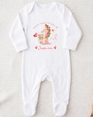 A white onesie with a personalized message and a cute illustration of a teddy bear.