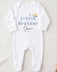 A white onesie with blue text and a construction vehicle graphic, indicating it is a baby onesie with a personalized message.