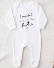 A white onesie with the text "I am perfect just like my Auntie" printed on it.