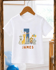 A white t-shirt with a graphic design featuring a blue number 1, surrounded by various cartoon animal characters, including a giraffe, zebra, and elephant.