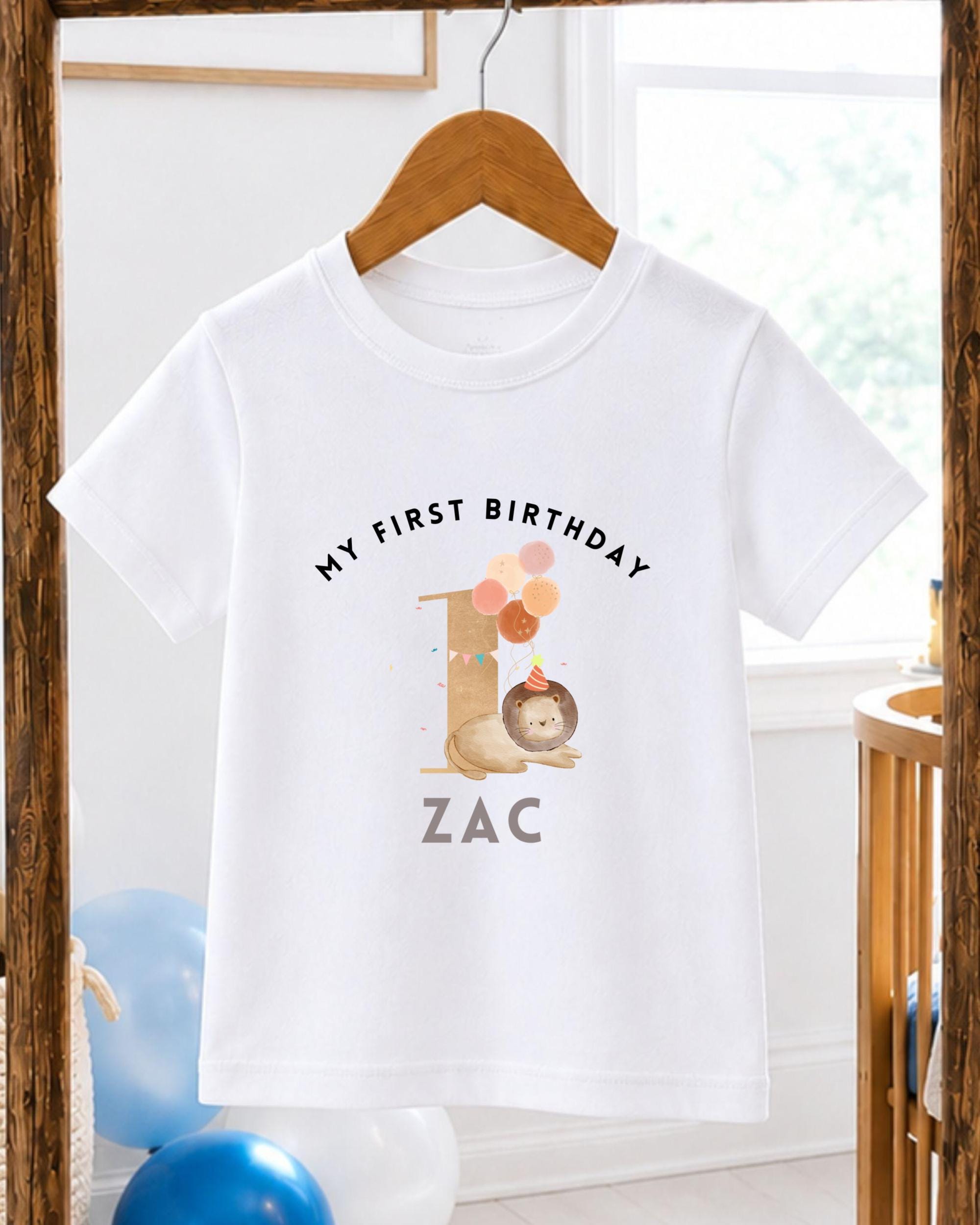 A white t-shirt with a personalized birthday message and a cartoon image of a lion.
