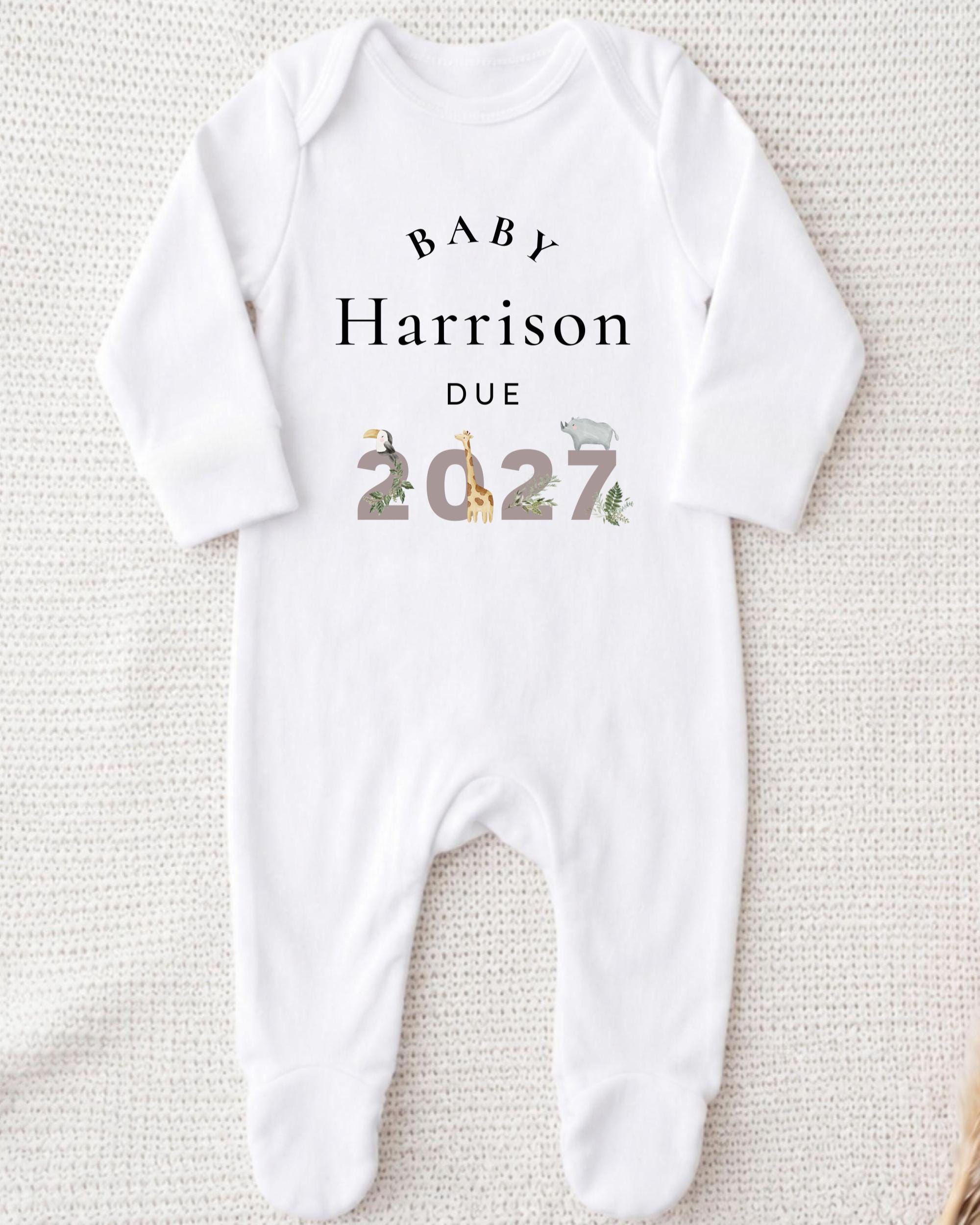 A white onesie with text and numbers printed on it.