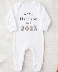 A white onesie with text and numbers printed on it.