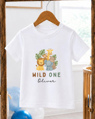 A white t-shirt with a graphic design of various animals, including a lion, giraffe, monkey, and elephant, along with the text "Wild One Oliver" printed on it.