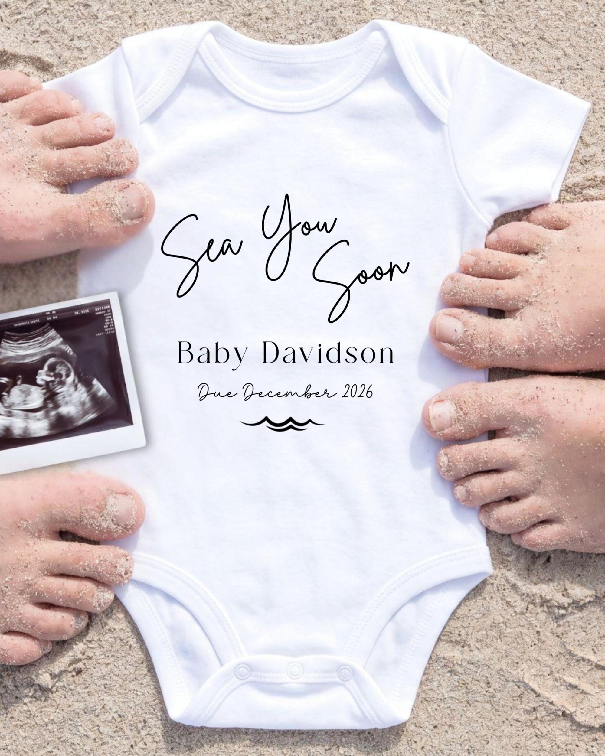 a white onesie with the text "Sea You Soon Baby Davidson Due December 2026" written on it, along with a black and white photograph of a baby's belly.
