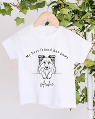 A white t-shirt with a black and white illustration of a dog's face and the text "My best friend has paws Archie" printed on it.