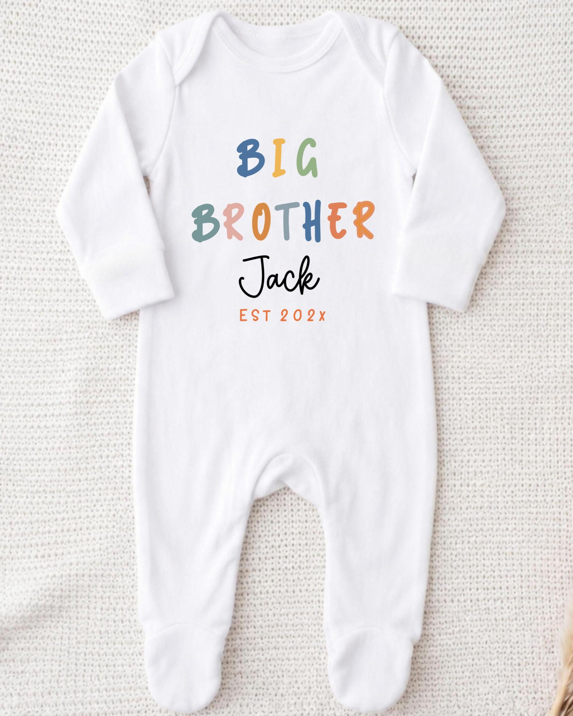 A white onesie with the text "BIG BROTHER Jack EST 2002" printed on it.
