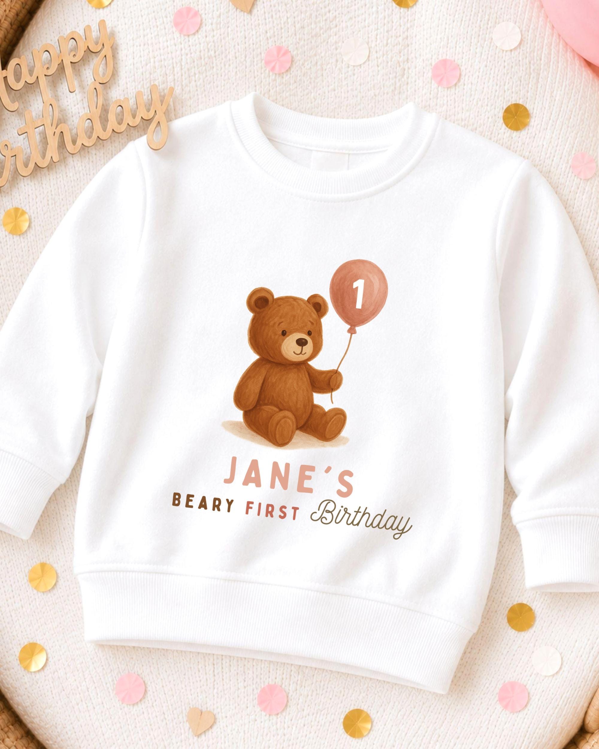 A white sweatshirt with a teddy bear and a balloon, along with the text "JANE'S BIRTHDAY" printed on it.