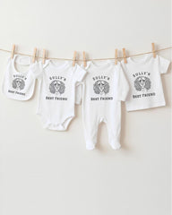 A row of white baby clothes with the text "Sully's BEST FRIEND" printed on them, along with a bib featuring the same text.