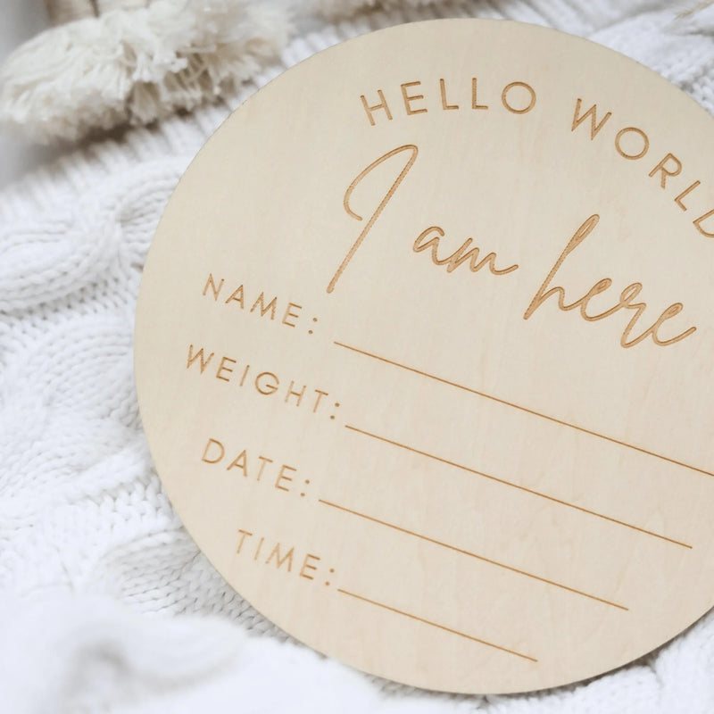 a wooden circle with a name and date on it