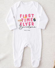 A white onesie with pink text and graphics printed on it.