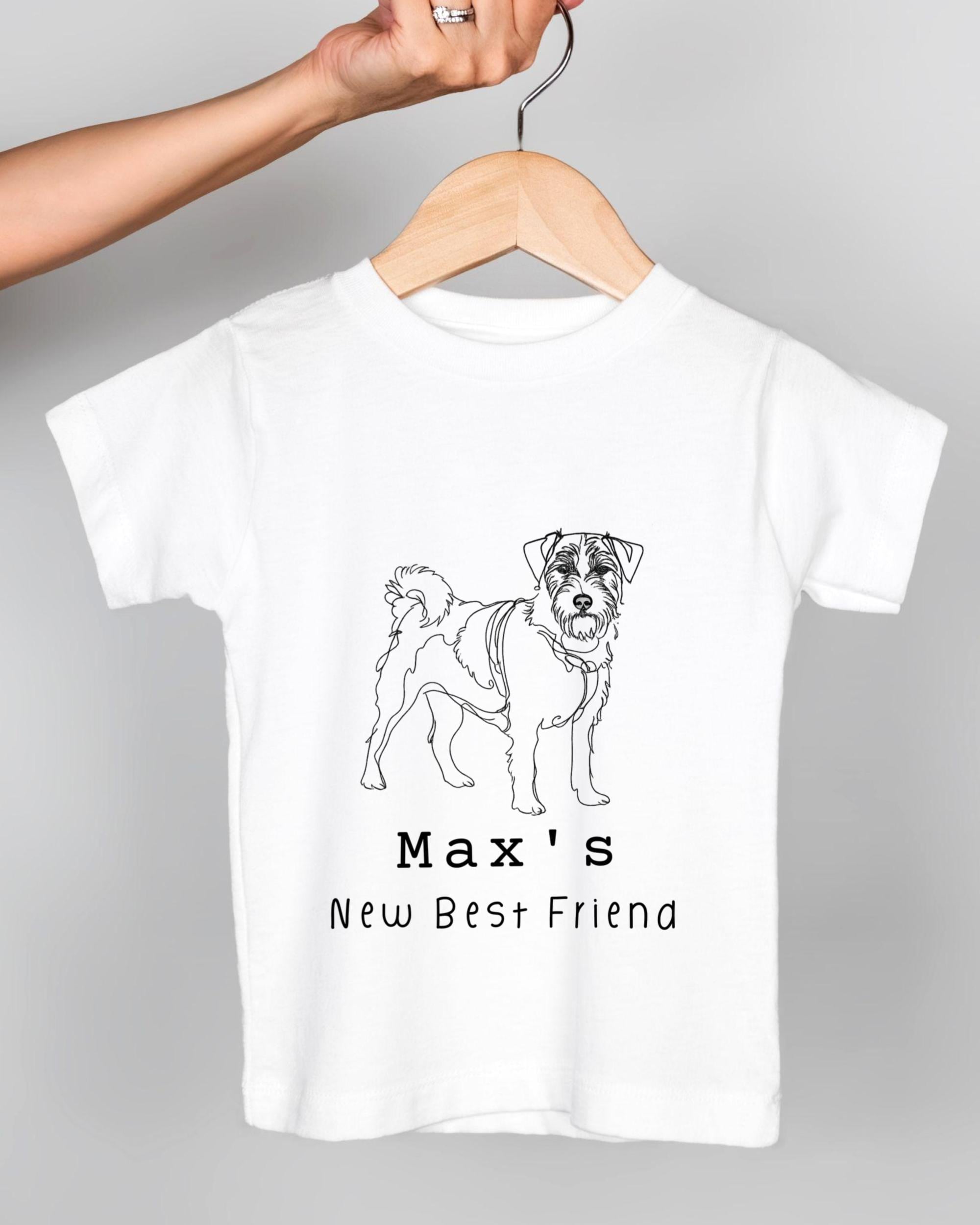 A white t-shirt with a black and white illustration of a dog and the text "Max's New Best Friend" printed on it.