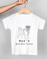A white t-shirt with a black and white illustration of a dog and the text "Max's New Best Friend" printed on it.