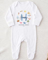 A white onesie with a personalized name and location printed on it.