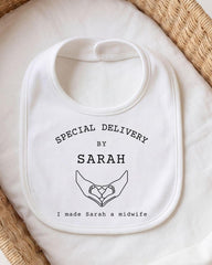 A white bib with text and a graphic design, placed on a white cloth.