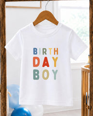 A white t-shirt with the text "BIRTHDAY BOY" printed on it in a colorful, playful font.