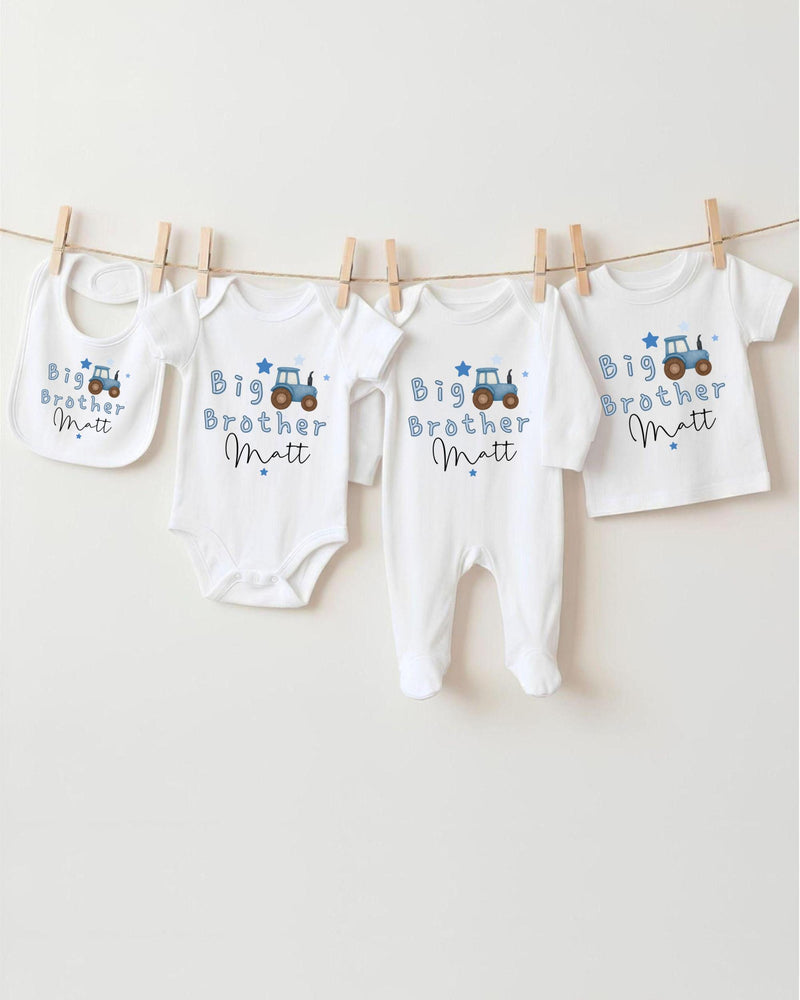 A row of four white baby clothes with blue designs, each labeled with the name "Big Brother Matt".