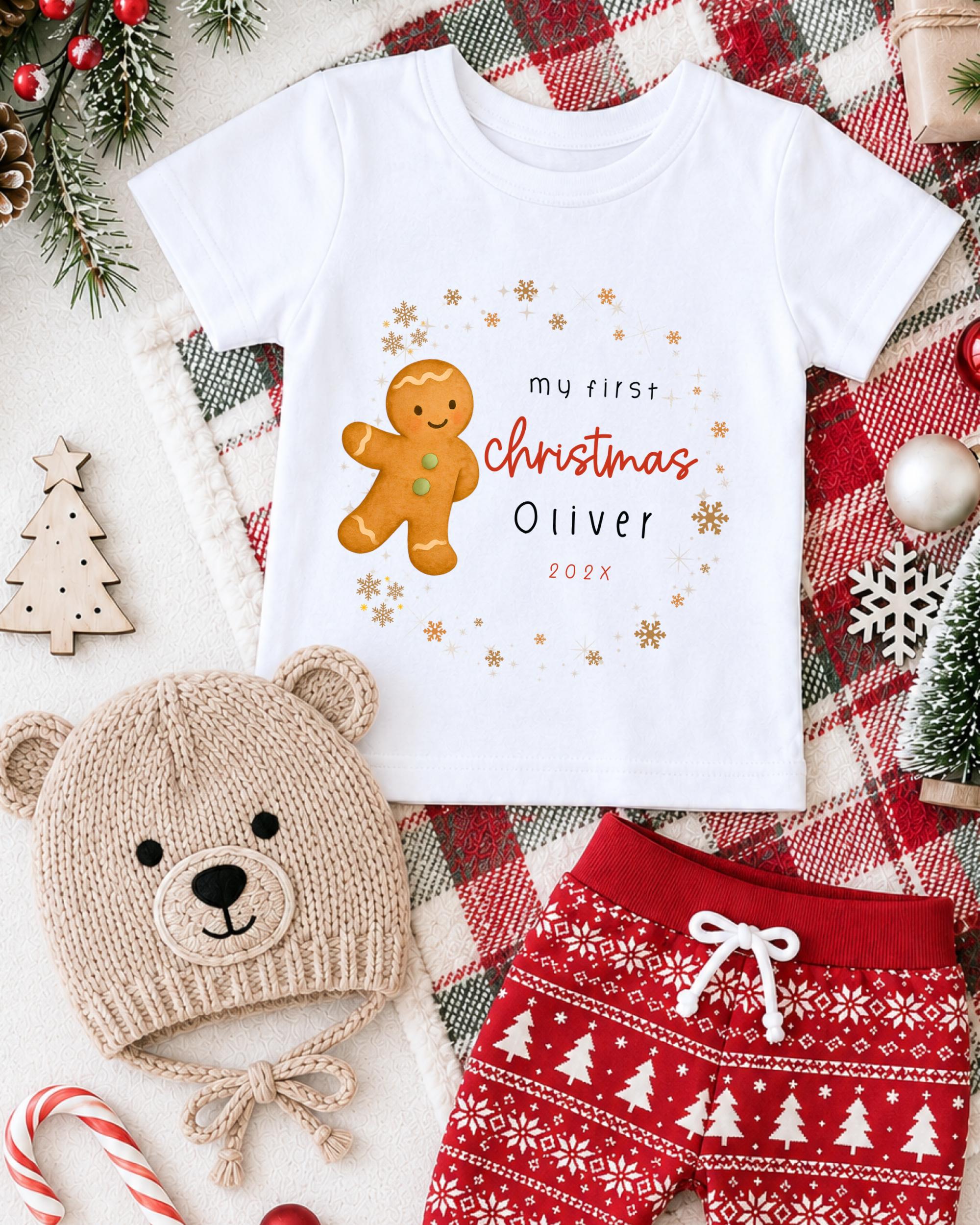 A white t-shirt with a gingerbread man graphic and text, a beige knit hat, red and white patterned shorts, and Christmas decorations such as a tree, candy canes, and snowflakes.