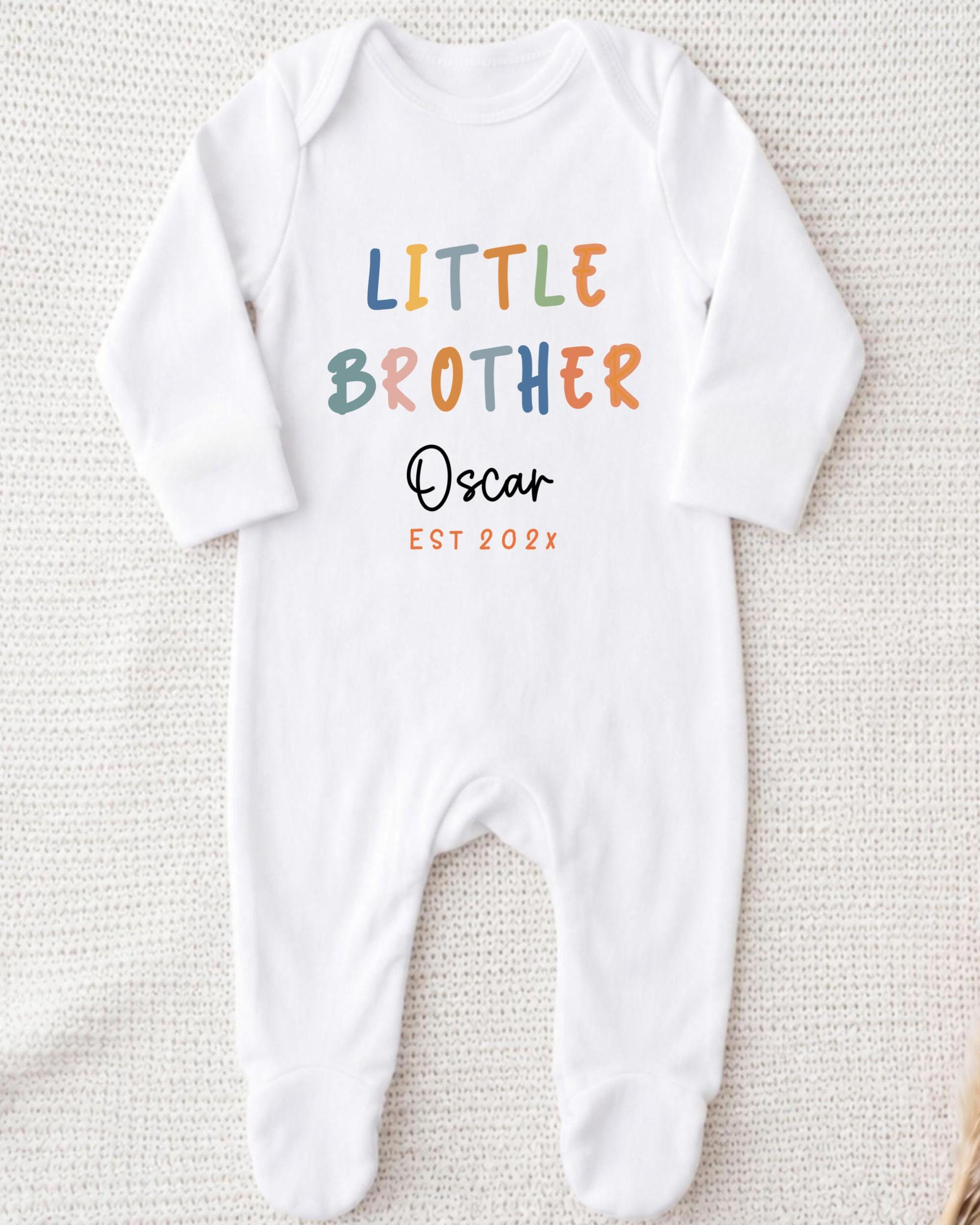 A white onesie with the text "Little Brother Oscar" printed on it.