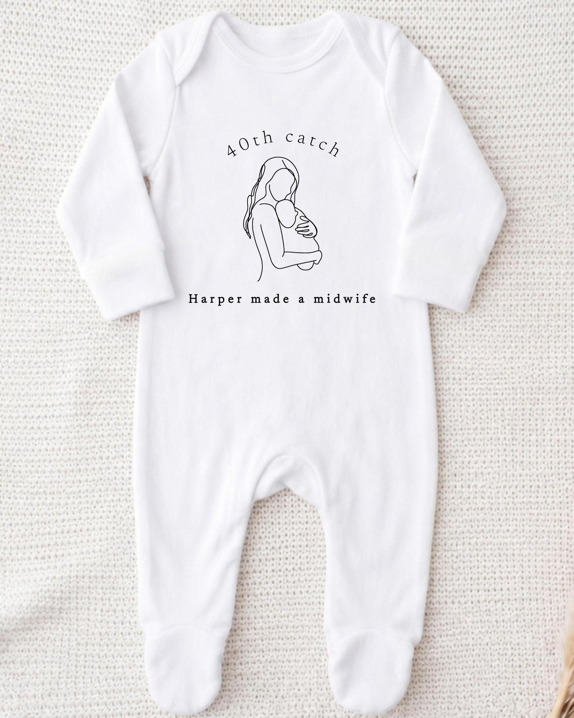 A white onesie with a graphic of a woman holding a baby and text that reads "40th catch Harper made a midwife".