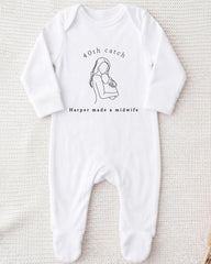 A white onesie with a graphic of a woman holding a baby and text that reads "40th catch Harper made a midwife".