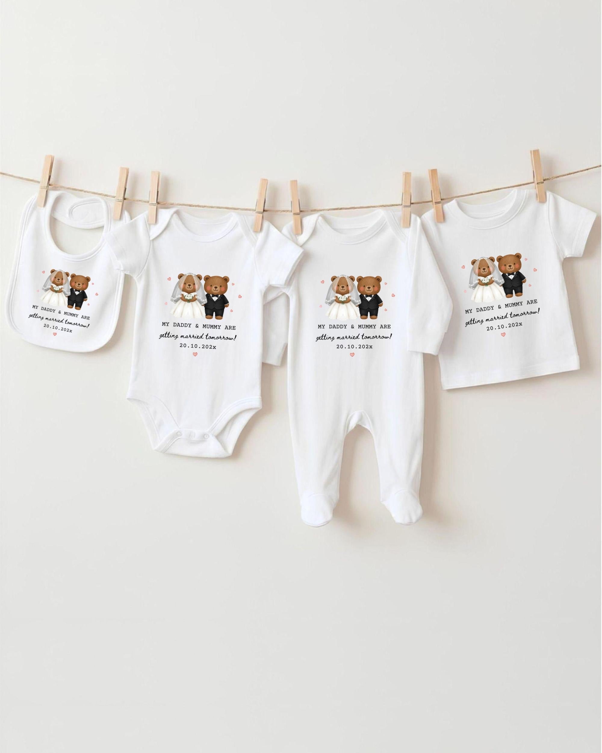 a collection of baby clothes, including onesies and bibs, hanging on a clothesline.