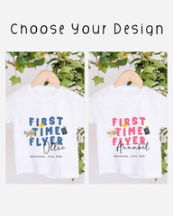 two white t-shirts hanging on a wooden hanger, each with a different design and text. The text on the t-shirts reads "FIRST TIME FLYER" and "FIRST TIME FLYERollie" respectively. The t-shirts are set against a backdrop of greenery, and the text "choose your design" is displayed above the t-shirts.