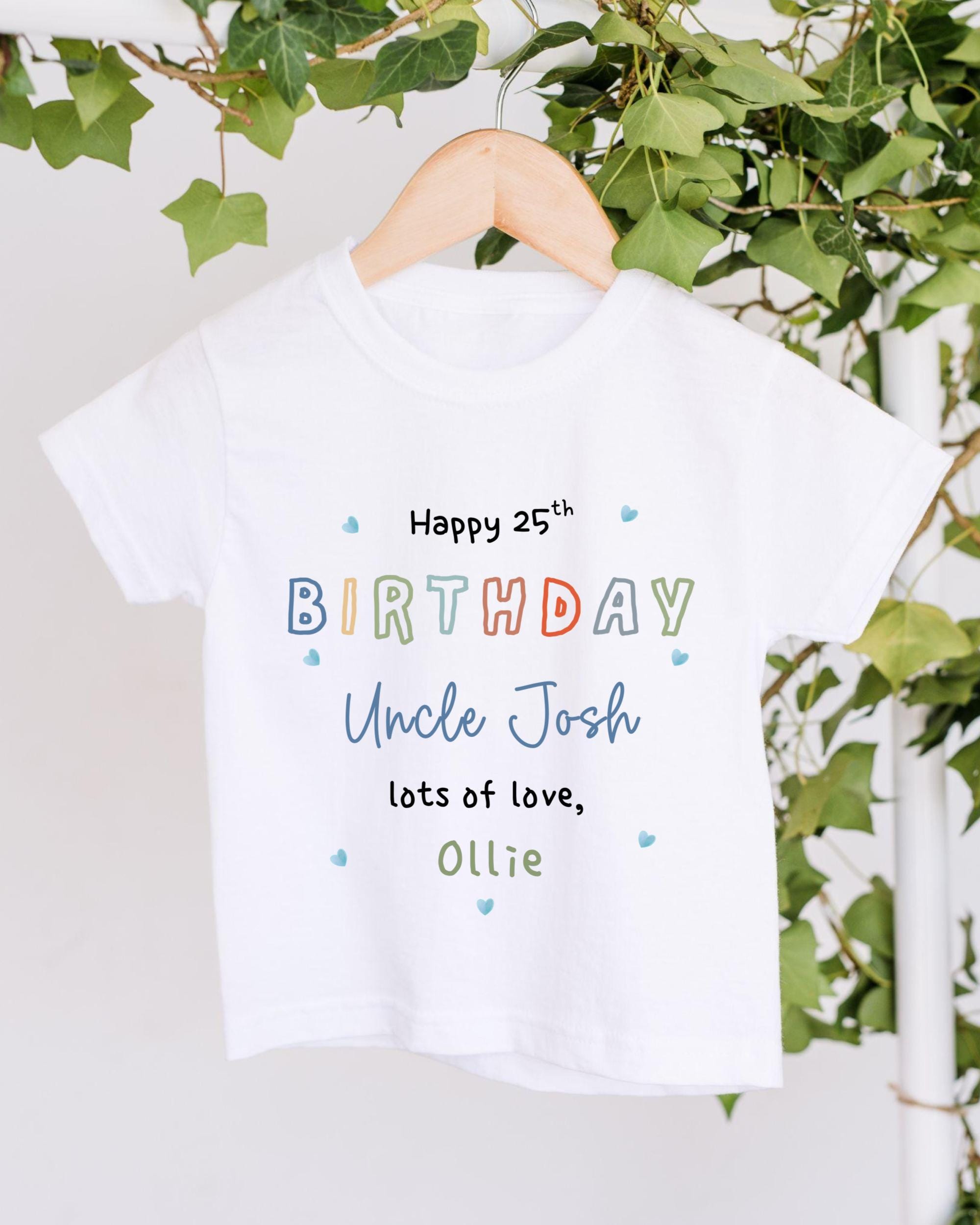 A white t-shirt with colorful text and a personalized message for Uncle Josh's 25th birthday.