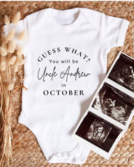 A white baby onesie with text that reads "Guess what? You will be Uncle Andrew in October" is displayed alongside a set of three black and white baby ultrasound images.
