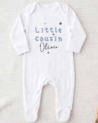 A white onesie with the text "Little Cousin Oliver" printed on it.