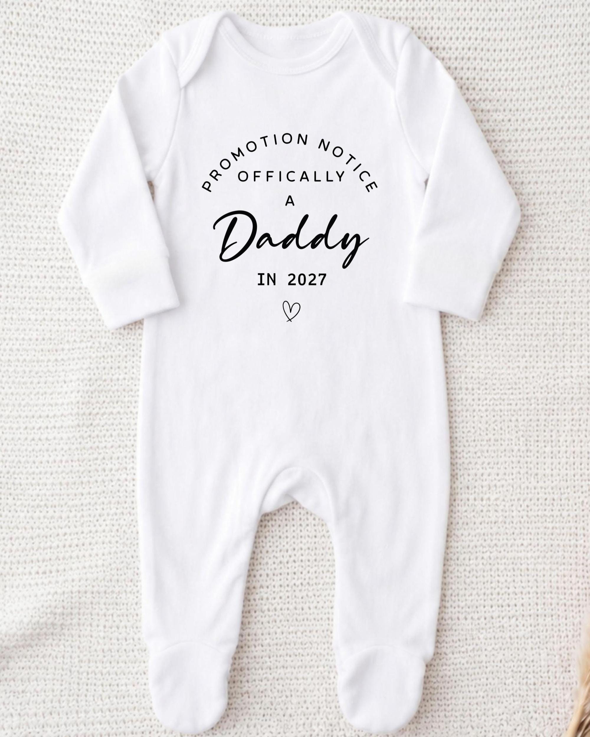 A white onesie with text printed on it.