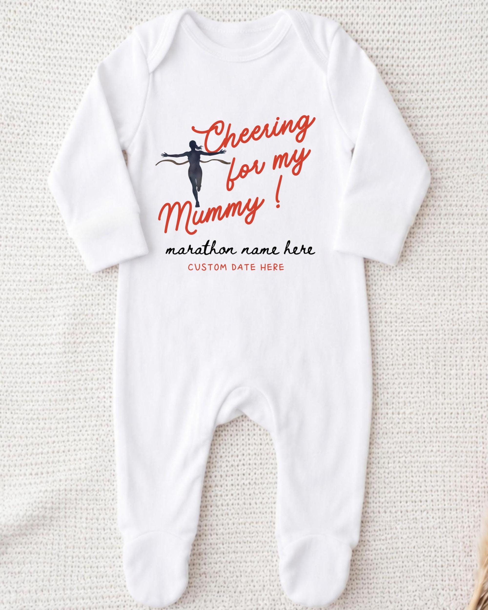 A white onesie with a graphic design and text printed on it.