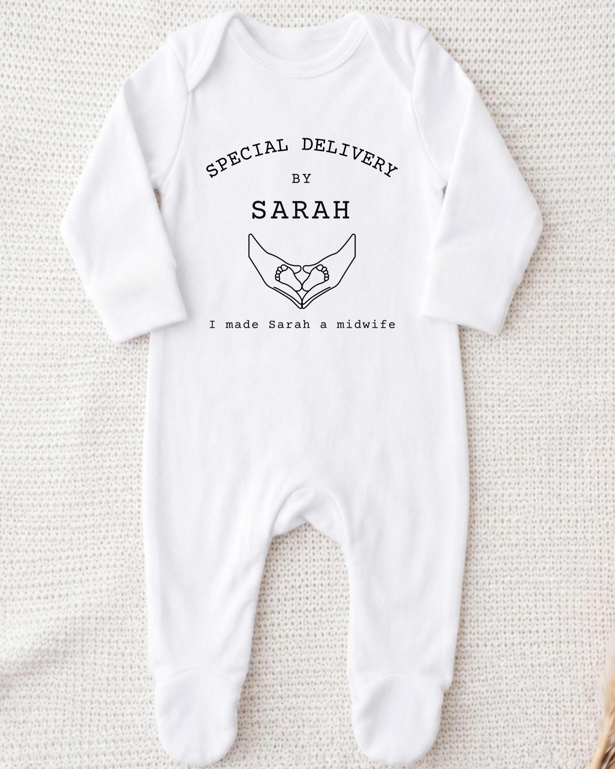A white onesie with text and a graphic design on it.