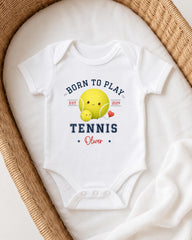 A white onesie with a tennis ball and a smiling tennis ball design, along with the text "Born to play TENNIS Oliver" printed on it.