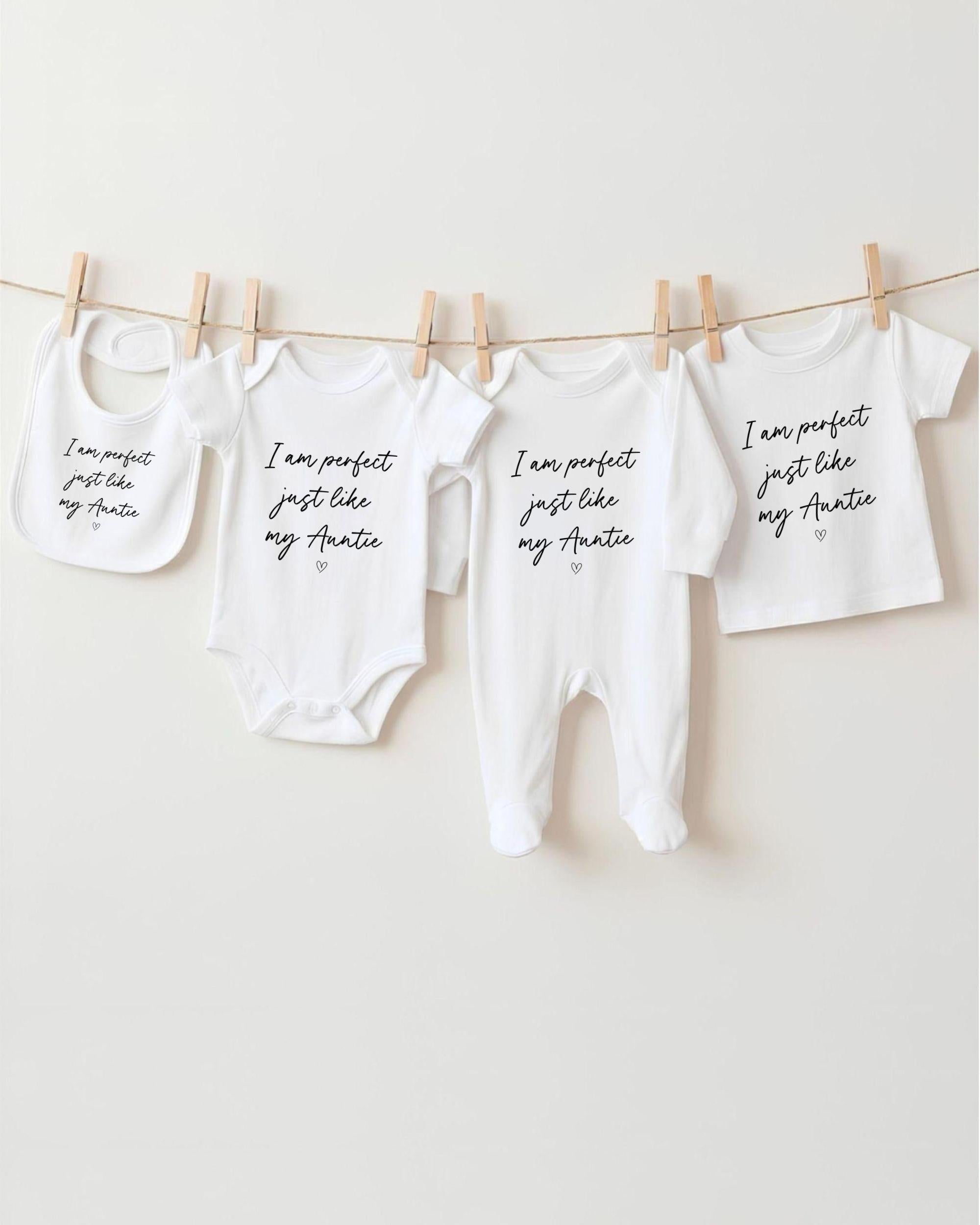 a collection of baby clothes hanging on a clothesline, with each piece featuring a unique message or description.