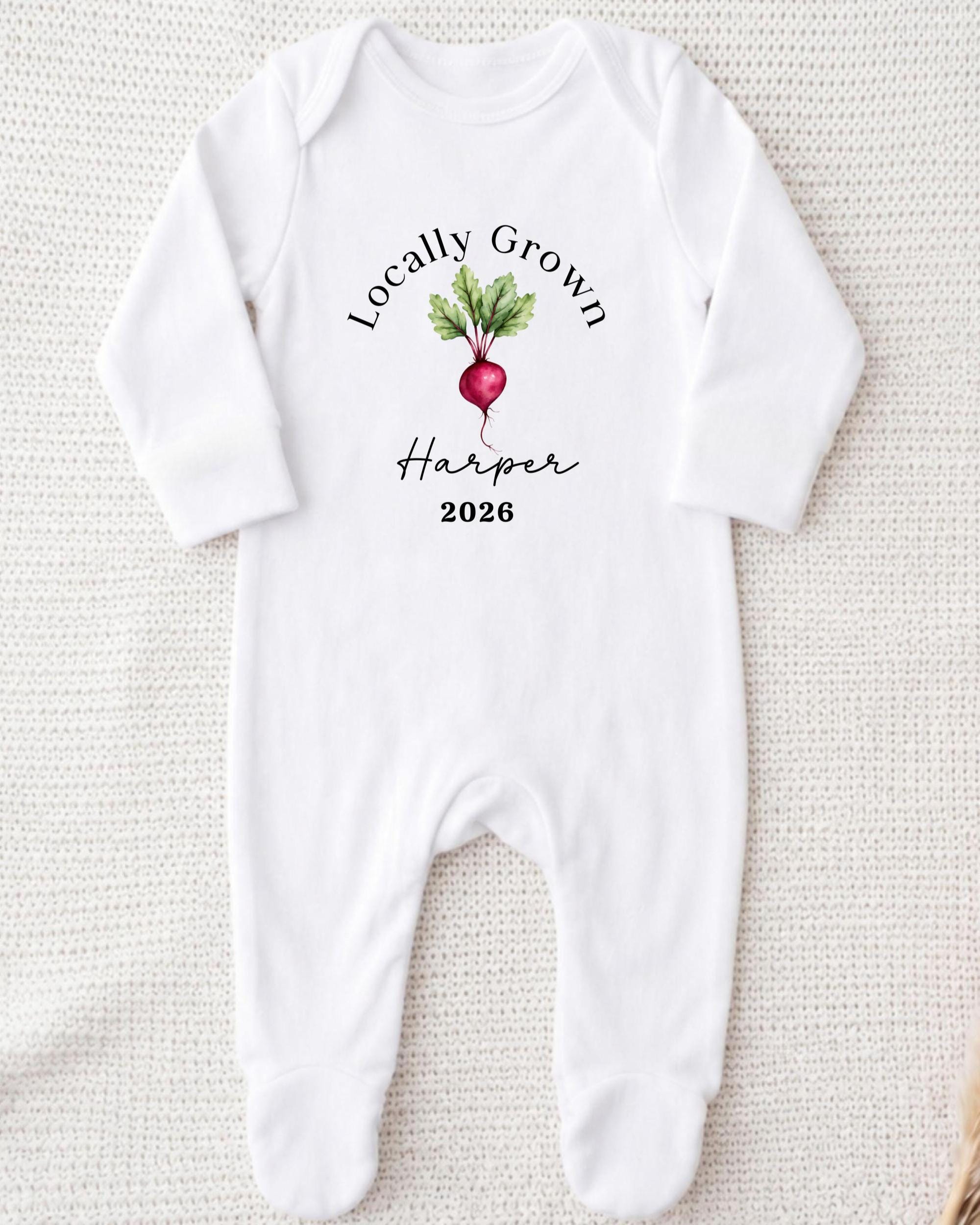 A white onesie with a graphic of a radish and the text "Locally Grown Harper 2026" printed on it.