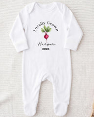 A white onesie with a graphic of a radish and the text "Locally Grown Harper 2026" printed on it.