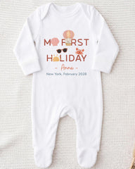 A white onesie with text and illustrations on it, laid out on a white background.