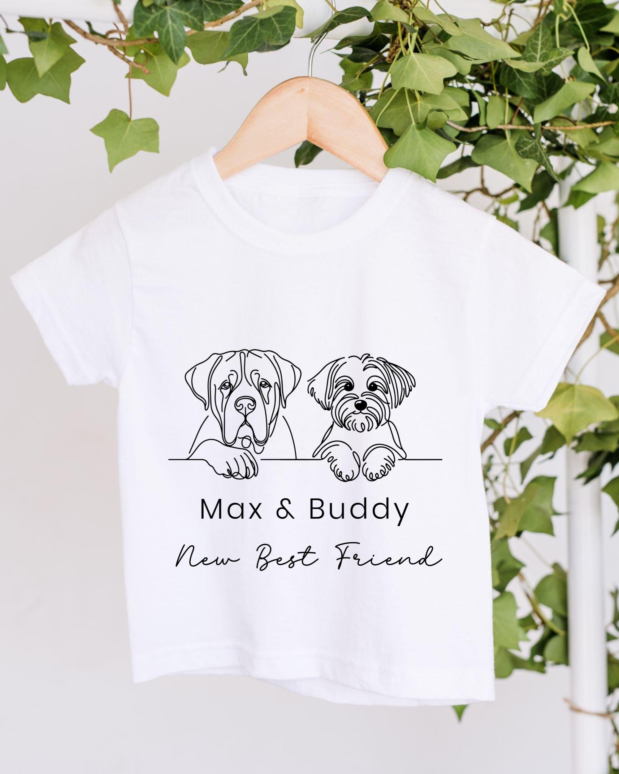 A white t-shirt with a graphic design of two dogs, one larger and one smaller, sitting together and the text "Max & Buddy New Best Friend" below the image.
