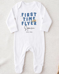 A white onesie with the text "FIRST TIME FLYER Spain July 2023" printed on it.