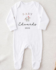 A white onesie with a baby elephant and the text "BABY Edwards 2026" printed on it.