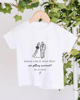 A white t-shirt with a graphic design of a bride and groom, along with text that reads "Aunnie Lisa & Uncle Matt are getting married! 20.10.2021".
