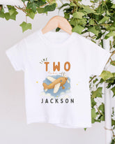 A white t-shirt with a graphic design of a cartoon airplane and the text "Time to take off Jackson" printed on it.