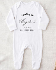 A white onesie with text printed on it, placed on a white background.