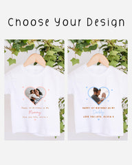 two white t-shirts hanging on a wooden hanger, each with a heart-shaped photo and a personalized message.
